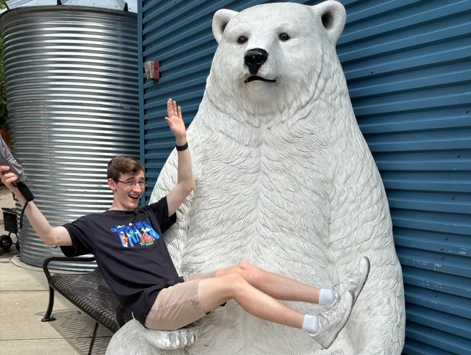 Thomas being held in the paw of a giant plastic polar bear